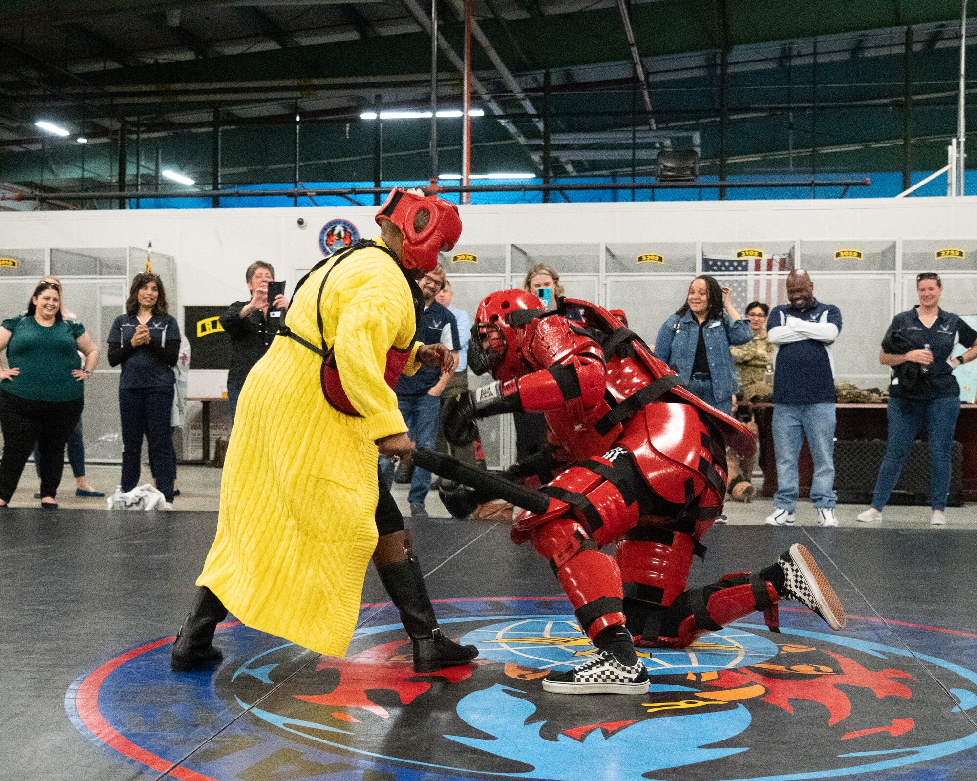 Dr. Eunice Gwanmesia, 436th Airlift Wing honorary commander, fends off a 436th Security Forces Squadron Phoenix Raven team member in a training suit during an immersion tour on Dover Air Force Base, Delaware, Feb. 23, 2023. Gwanmesia is one of forty-one local civic and business leaders who were recently inducted into the HCC program. (U.S. Air Force photo by Mauricio Campino)