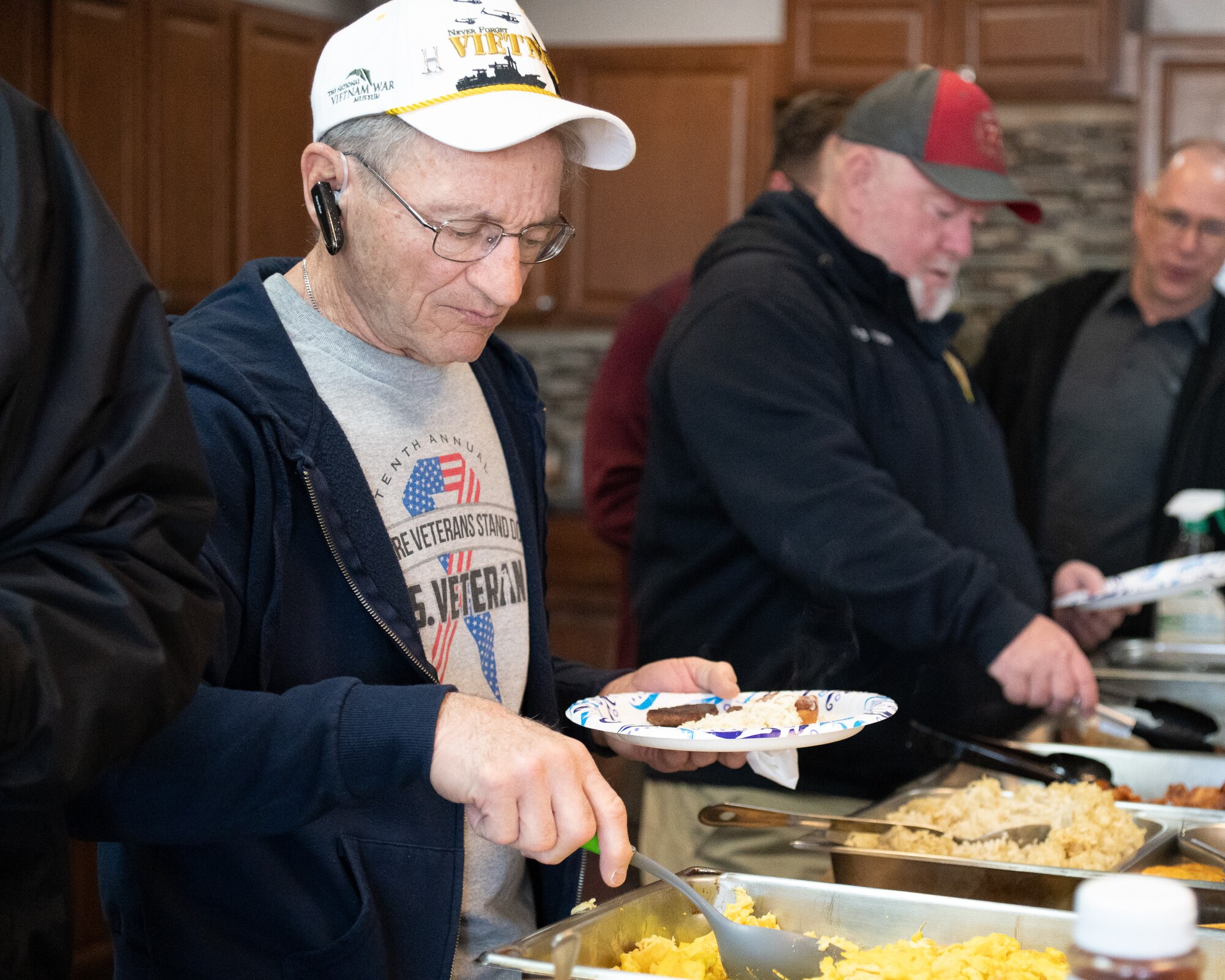 Retired firefighters grab breakfast during a veteran firefighter reunion on Dover Air Force Base, Delaware, Feb. 24, 2023. The 436th Civil Engineer Squadron fire department hosted the tour and welcomed 10 retired Team Dover firefighters to tour the modernized facilities and share their experiences with Airmen. (U.S. Air Force photo by Mauricio Campino)