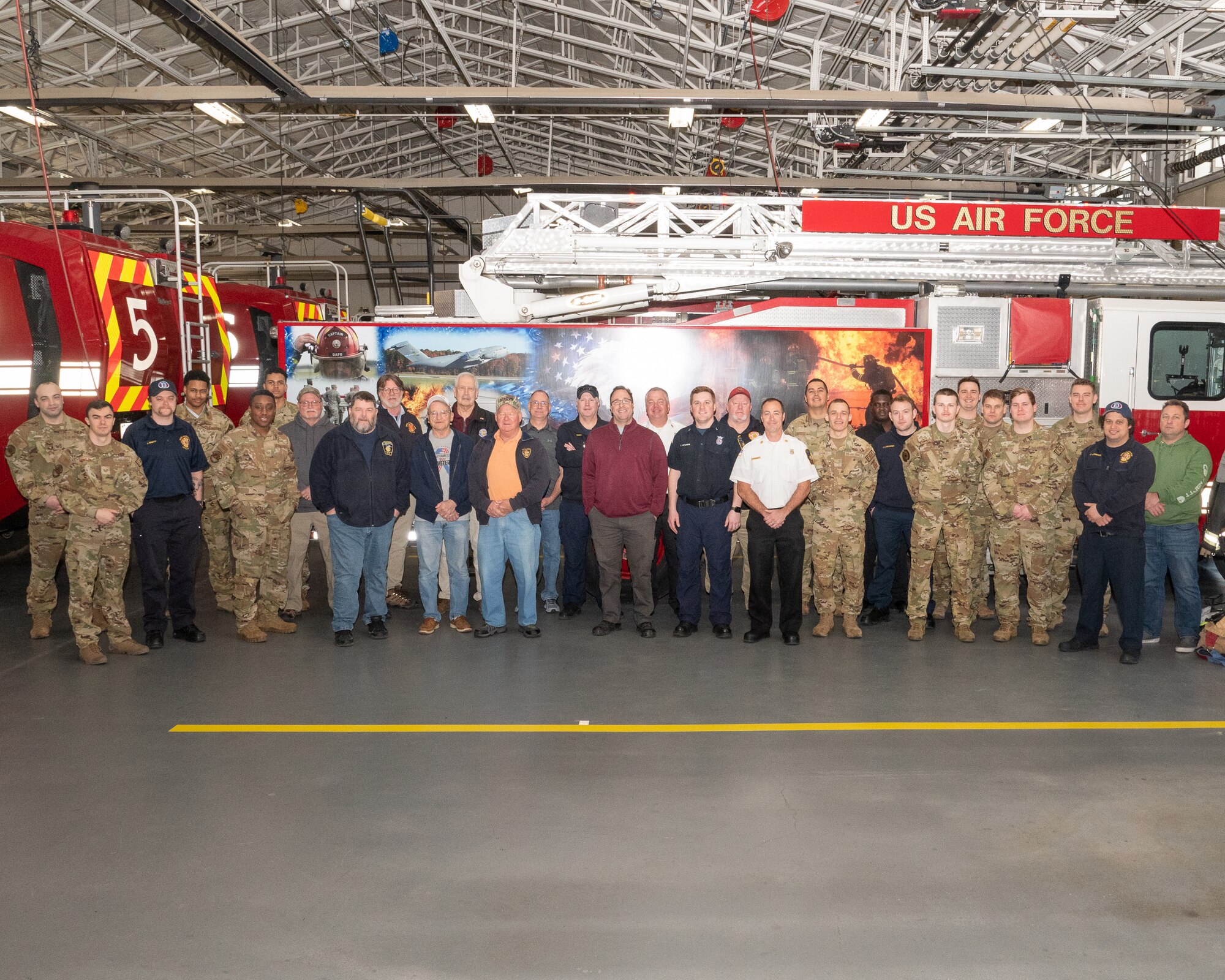 Current and retired Dover Air Force Base, Delaware, firefighters pose for a group photo during a veteran firefighter reunion on Dover AFB, Feb. 24, 2023. The 436th Civil Engineer Squadron fire department hosted the tour and welcomed 10 retired Team Dover firefighters to tour the modernized facilities and share their experiences with Airmen. (U.S. Air Force photo by Mauricio Campino)
