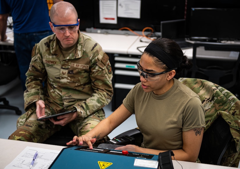U.S. Air Force Tech. Sgt. Paul Chadwick, 305th Maintenance Squadron Precision Measurement Equipment Laboratory quality manager, evaluates U.S. Air Force Staff Sgt. Jasmine Ozoude, 305th Maintenance Squadron Precision Measurement Equipment Laboratory assurance evaluator, on the calibration of at Joint Base McGuire-Dix-Lakehurst, N.J., Feb. 23, 2023. PMEL technicians at JB MDL sustain the Joint Force by providing precise, reliable and traceable equipment to mission partners across the tri-state area. (U.S. Air Force photo by Senior Airman Sergio Avalos)