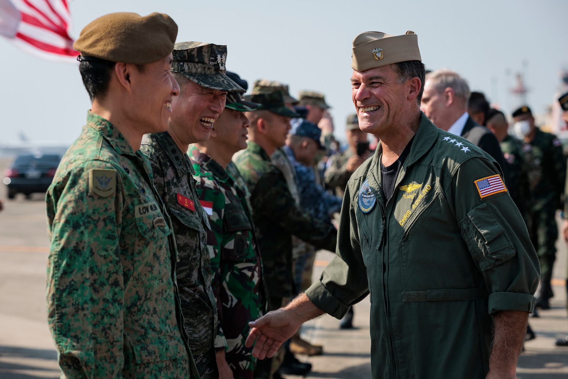 U.S. Navy Adm. Chris Aquilino, commander of U.S. Indo-Pacific Command, greets service members from participating nations during the opening ceremony of Exercise Cobra Gold at Utapao International Airport, Ban Chang district, Rayong province, Kingdom of Thailand, Feb. 28, 2023.
