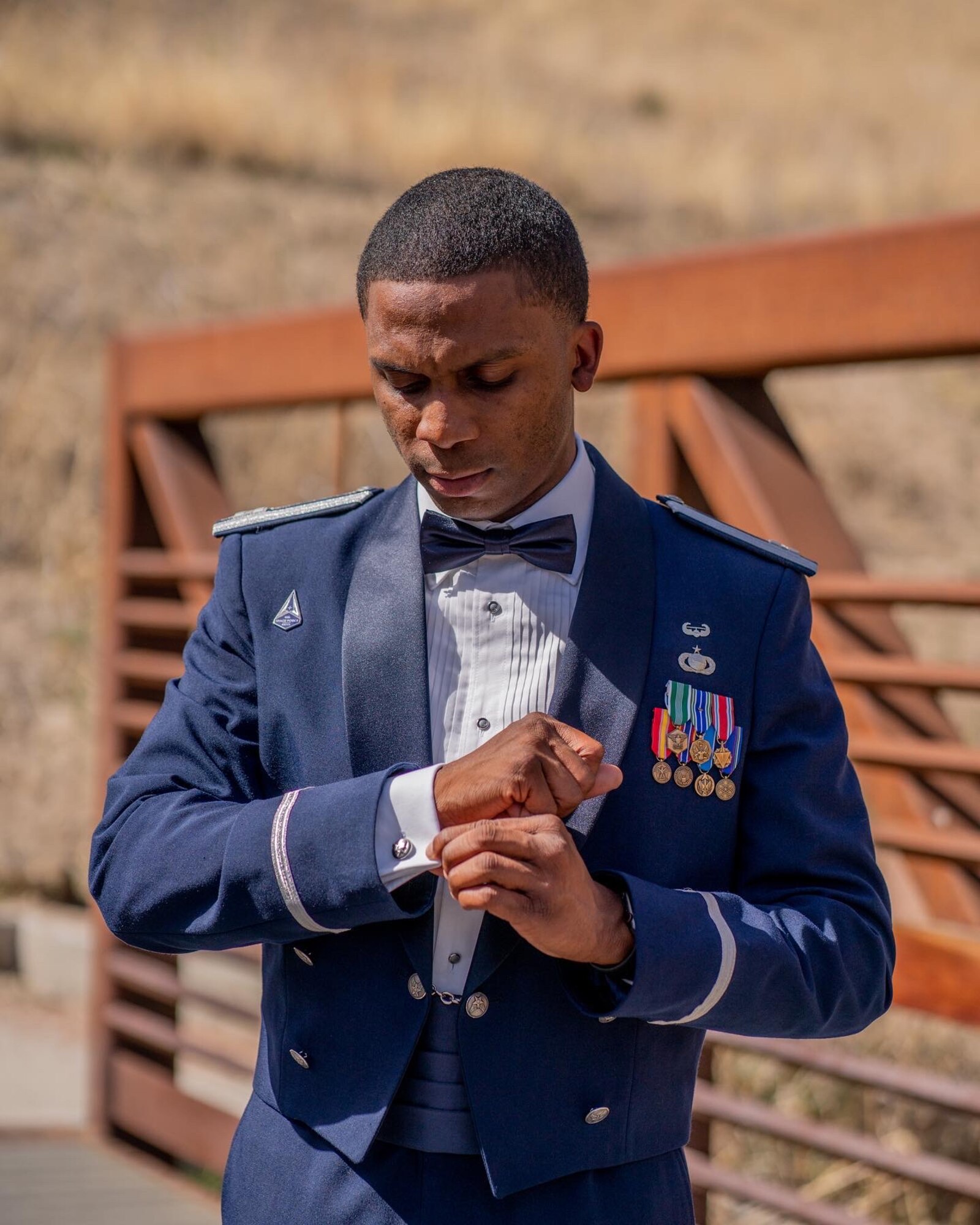 Service member fixing their service dress