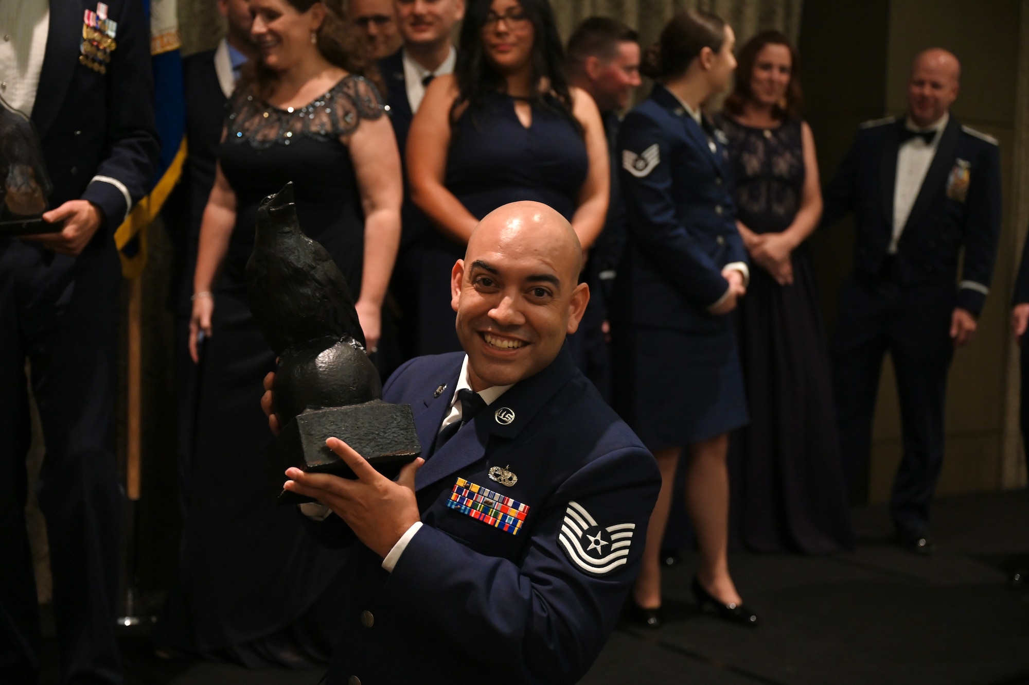 U.S. Air Force Tech. Sgt. Armando Largaespada, 39th Electronic Warfare Squadron operations superintendent, holds the Unit of the Year Trophy at the 350th Spectrum Warfare Wing’s annual awards ceremony at Eglin, Air Force Base, Fla., Feb. 24, 2023. The 39th EWS were selected as the wing’s first unit of the year and had their name inscribed on the Crow trophy. (U.S. Air Force photo by 1st Lt Benjamin Aronson)