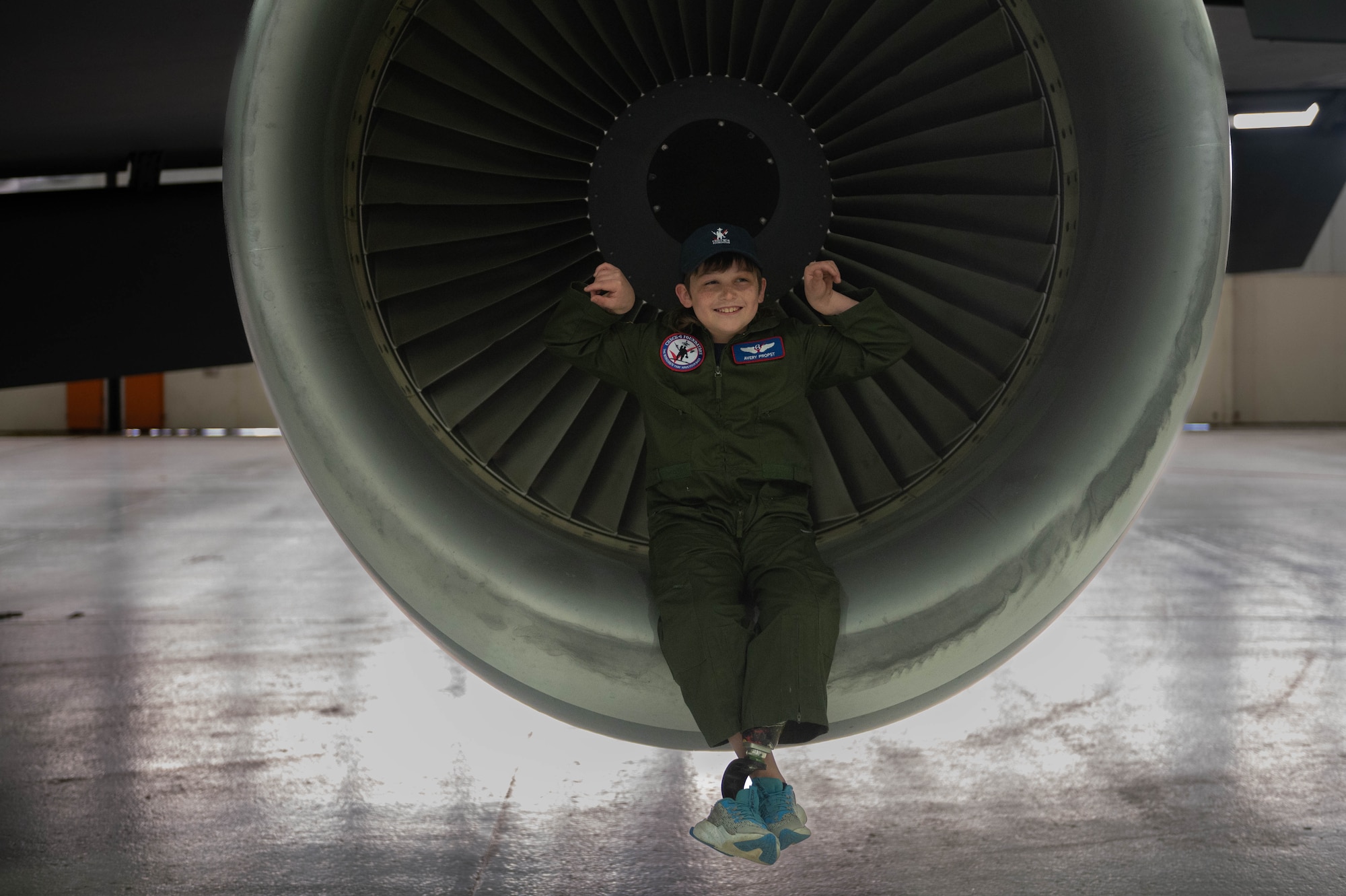 Boy sits in plane engine