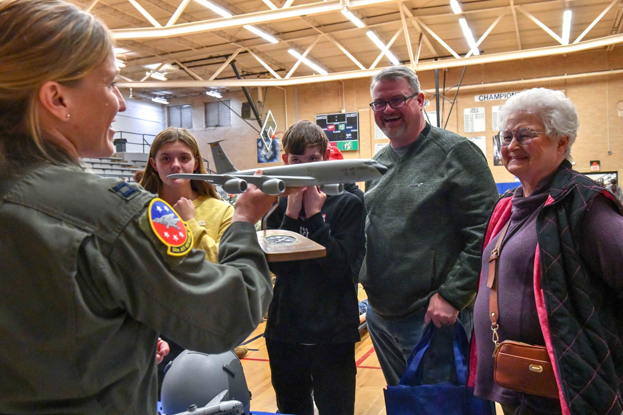 U.S. Air Force Capt. Aimee Parenti, 54th Air Refueling Squadron assistant flight commander, displays a model of a KC-135 Stratotanker during an aviation fair at Altus Air Force Base, Oklahoma, Feb. 25, 2023. During the fair, attendees were exposed to flight simulators of the KC-135, KC-46 Pegasus and the C-17 Globemaster. (U.S. Air Force photo by Airman 1st Class Miyah Gray)