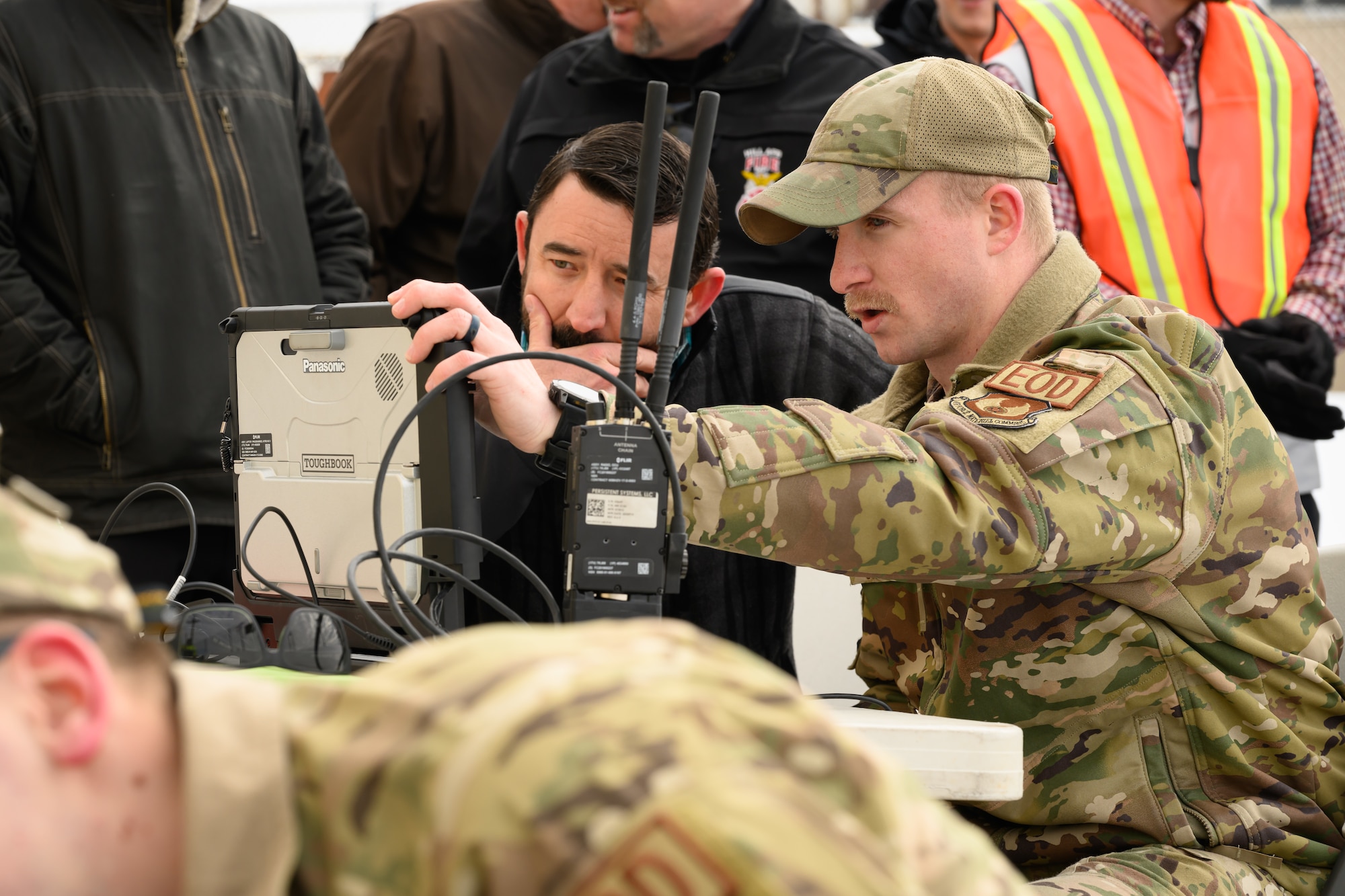 Two men look at a video monitor