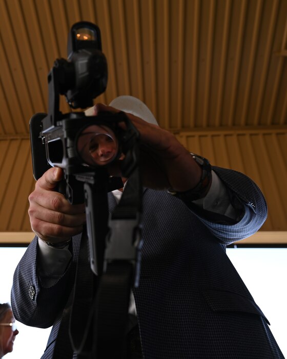 17th Training Wing Honorary Commander, Trey Holmes, looks through the optics of a M320 grenade launcher during a weapons demonstration at Goodfellow Air Force Base, Texas, Feb. 28, 2023. The M320 Grenade Launcher can be used as a stand alone device or be attached to the underside of another weapon. (U.S. Air Force photo by Airman 1st Class Zachary Heimbuch)