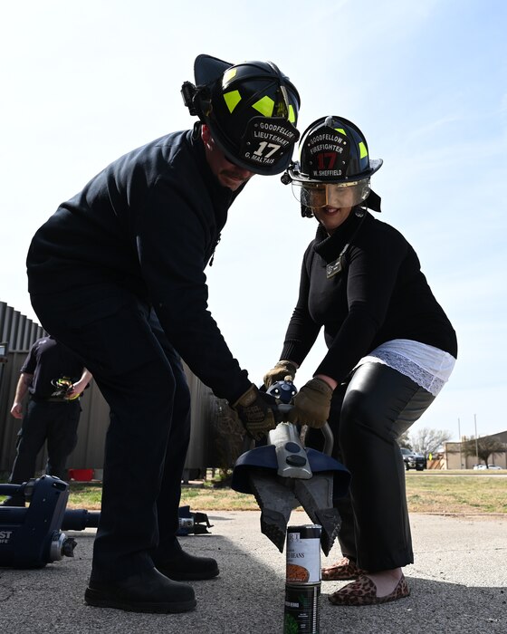 17th Training Wing Honorary Commander, Jenna Jones, holds the Jaws of Life, demonstrating the accuracy of the machine, Goodfellow Air Force Base, Texas, Feb. 28, 2023. The Jaws of Life are used by the fire department to save and protect lives in a variety of situations. (U.S. Air Force photo by Airman 1st Class Zachary Heimbuch)