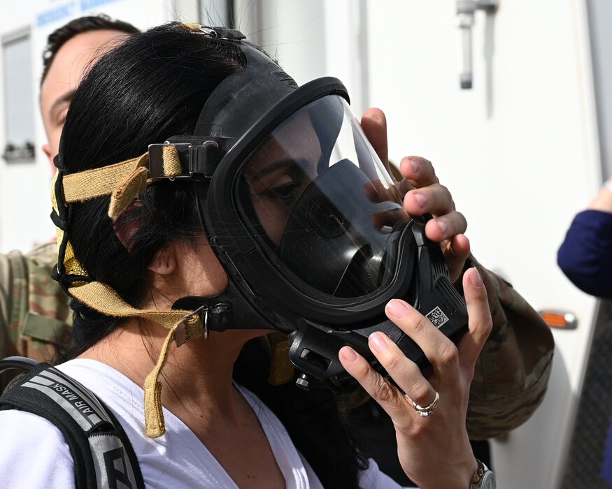 17th Training Wing Honorary Commander, Floe Leos Madero dawns hazardous materials protective equipment while touring a Emergency Response Trailer. ERTs can be used in a multitude of situations from temporary working stations to hazardous materials instant command areas.