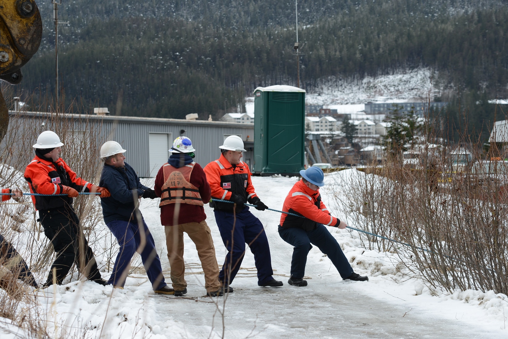 Coast Guard Sector Juneau servicemembers and a contractor pull a line attached to a cable at the bow of the sunken vessel Tagish in Gastineau Channel, Juneau, Alaska, Feb. 9, 2023