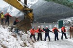 Coast Guard Sector Juneau servicemembers and contractors pull a line attached to a cable at the bow of the sunken vessel Tagish in Gastineau Channel, Juneau, Alaska, Feb. 9, 2023.