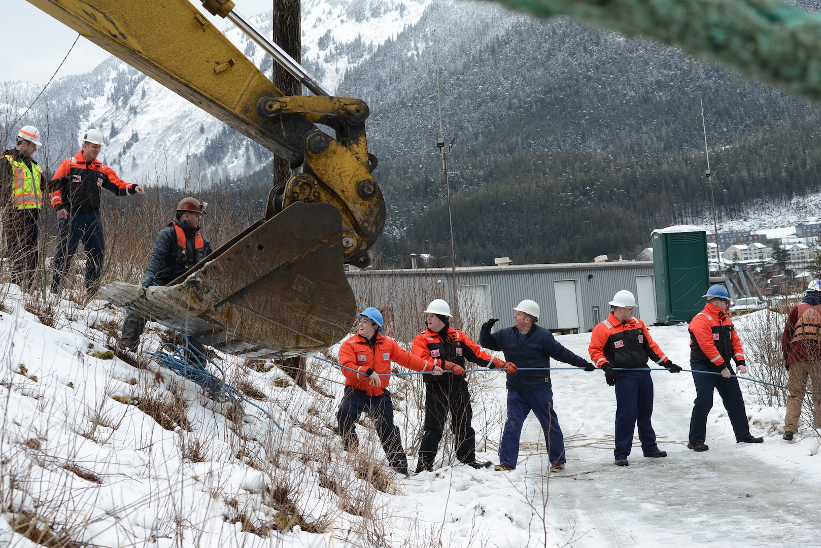 Coast Guard Sector Juneau servicemembers and contractors pull a line attached to a cable at the bow of the sunken vessel Tagish in Gastineau Channel, Juneau, Alaska, Feb. 9, 2023.