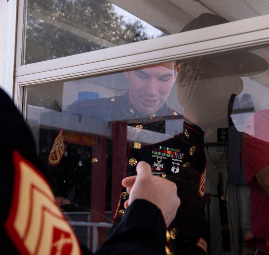 Staff Sgt. Mark Gulotta, with Recruit Training Regiment, narrates a recruit graduation on Marine Corps Recruit Depot  Parris Island, S.C., Feb 25, 2022. Gulotta completed his first graduation ceremony on February 25. (U.S. Marine Corps photo by Lance Cpl. Michelle Brudnicki)