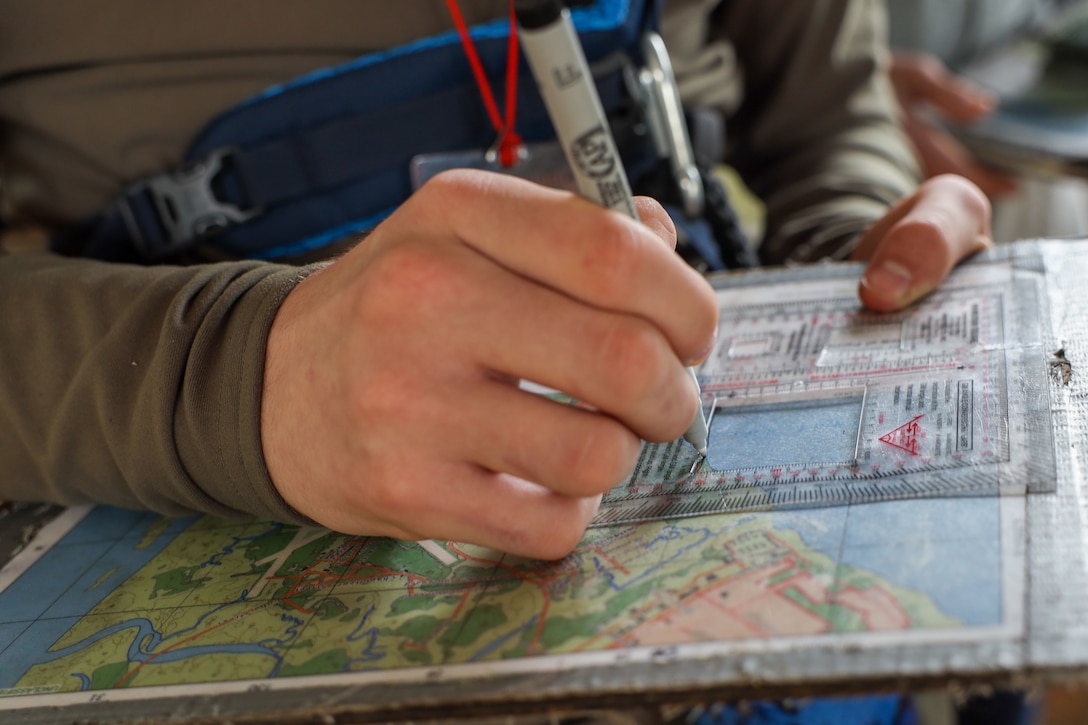 Boy Scouts from Troop 241 learn land navigation techniques aboard Marine Corps Recruit Depot Parris Island, S.C., on March 19, 2022. The scouts were taught the techniques by Field Training Company Instructors, and learned how to implement these techniques in their journeys as scouts to earn their Orienteering Merit Badge.  (U.S. Marine Corps photo by Lance Cpl. Dakota Dodd)