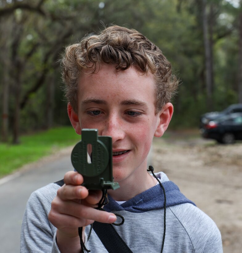 Boy Scouts from Troop 241 learn land navigation techniques aboard Marine Corps Recruit Depot Parris Island, S.C., on March 19, 2022. The scouts were taught the techniques by Field Training Company Instructors, and learned how to implement these techniques in their journeys as scouts to earn their Orienteering Merit Badge. 
(U.S. Marine Corps photo by Lance Cpl. Dakota Dodd)