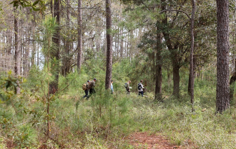 Boy Scouts from Troop 241 learn land navigation techniques aboard Marine Corps Recruit Depot Parris Island, S.C., on March 19, 2022. The scouts were taught the techniques by Field Training Company Instructors, and learned how to implement these techniques in their journeys as scouts to earn their Orienteering Merit Badge. 
(U.S. Marine Corps photo by Lance Cpl. Dakota Dodd)