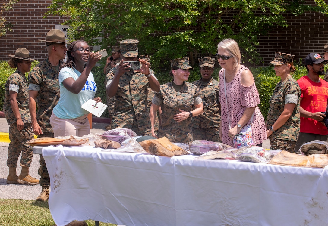 Item from within a time capsule are placed on a table for display on Marine Corps Recruit Depot Parris Island S.C., May 5, 2022. The items in the time capsule are from drill instructors, officers, and veterans who were present for the 69th anniversary celebration of women permanently serving in the Marine Corps. (U.S. Marine Corps photo by Lance Cpl. Michelle Brudnicki)