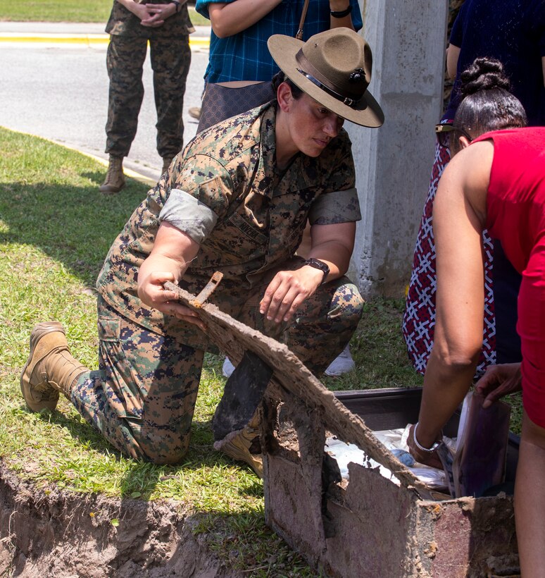 Sgt. Maj. Robin C. Fortner (Ret.) and Sgt. Maj. Sigrid Rivera, 4th Recruit Training Battalion Sergeant Major, open a time capsule buried ten years earlier on Marine Corps Recruit Depot Parris Island S.C., May 5, 2022. The time capsule was buried on the 69th anniversary of women permanently serving in the Marine Corps on February 13, 2012 by the command deck of 4th RTBN and the Women Marines Association. (U.S. Marine Corps photo by Lance Cpl. Michelle Brudnicki)