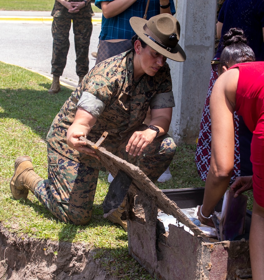 Sgt. Maj. Robin C. Fortner (Ret.) and Sgt. Maj. Sigrid Rivera, 4th Recruit Training Battalion Sergeant Major, open a time capsule buried ten years earlier on Marine Corps Recruit Depot Parris Island S.C., May 5, 2022. The time capsule was buried on the 69th anniversary of women permanently serving in the Marine Corps on February 13, 2012 by the command deck of 4th RTBN and the Women Marines Association. (U.S. Marine Corps photo by Lance Cpl. Michelle Brudnicki)
