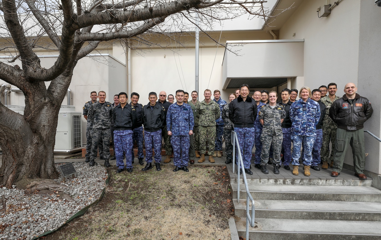 YOKOSUKA, Japan (Feb. 15, 2023) Sailors from the U.S. Navy, Japan Maritime Self-Defense Force (JMSDF), and Royal Australian Armed Forces from the Australian Headquarters Joint Operations Command (HQJOC) from the Australian Headquarters Joint Operations Command (HQJOC) pose for a photo following the trilateral theater anti-submarine warfare (TASW) tabletop exercise (TTX) at Commander, Fleet Activities Yokosuka. The TTX was held to improve information sharing, coordination, and communication between the three countries and across all domains of undersea warfare. (U.S. Navy photo by Mass Communication Specialist 2nd Class Arthur Rosen)