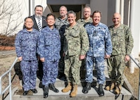 YOKOSUKA, Japan (Feb. 16, 2023) Senior leaders from the U.S. Navy, Japan Maritime Self-Defense Force (JMSDF), Royal Australian Air Force (RAAF) and Royal Australian Navy (RAN) pose for a photo following the trilateral theater anti-submarine warfare (TASW) working group (TTASWWG) at Commander, Fleet Activities Yokosuka. The TTASWWG helped improve information sharing, coordination, and communication between the three countries and across all domains of undersea warfare. (U.S. Navy photo by Mass Communication Specialist 2nd Class Arthur Rosen)