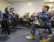 YOKOSUKA, Japan (Feb. 15, 2023) Sailors from the U.S. Navy, Japan Maritime Self-Defense Force (JMSDF), and Royal Australian Armed Forces from the Australian Headquarters Joint Operations Command (HQJOC) discuss lessons learned during the trilateral theater anti-submarine warfare (TASW) tabletop exercise (TTX) at Commander, Fleet Activities Yokosuka. The TTX was held to improve information sharing, coordination, and communication between the three countries and across all domains of undersea warfare. (U.S. Navy photo by Mass Communication Specialist 2nd Class Arthur Rosen)
