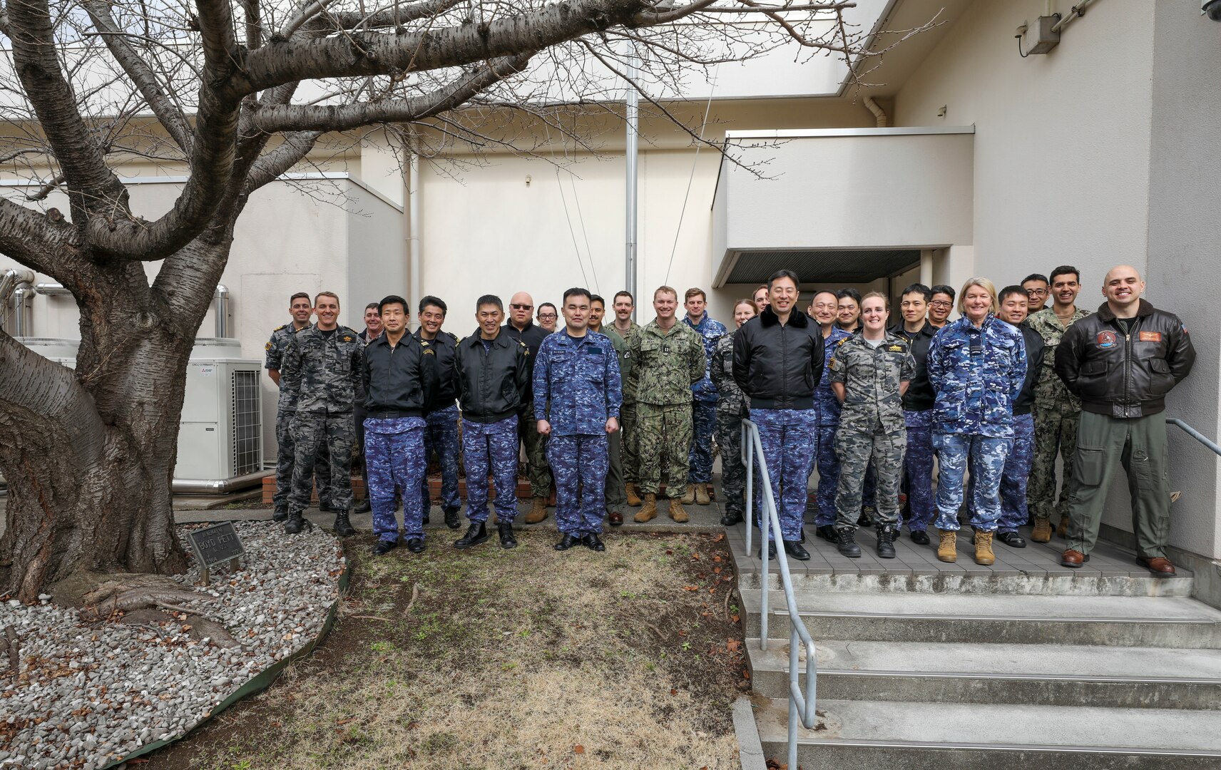 YOKOSUKA, Japan (Feb. 15, 2023) Sailors from the U.S. Navy, Japan Maritime Self-Defense Force (JMSDF), and Royal Australian Armed Forces from the Australian Headquarters Joint Operations Command (HQJOC) from the Australian Headquarters Joint Operations Command (HQJOC) pose for a photo following the trilateral theater anti-submarine warfare (TASW) tabletop exercise (TTX) at Commander, Fleet Activities Yokosuka. The TTX was held to improve information sharing, coordination, and communication between the three countries and across all domains of undersea warfare. (U.S. Navy photo by Mass Communication Specialist 2nd Class Arthur Rosen)