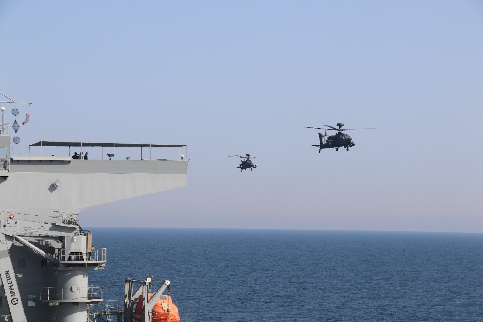 ARABIAN GULF (Feb. 22, 2023) Two United Arab Emirates Armed Forces AH-64D Long Bow Apaches conduct deck landing qualifications aboard expeditionary sea base USS Lewis B. Puller (ESB 3) in the Arabian Gulf, Feb. 22, 2023. Puller is deployed to the U.S. 5th Fleet area of operations to help ensure maritime security and stability in the Middle East region.