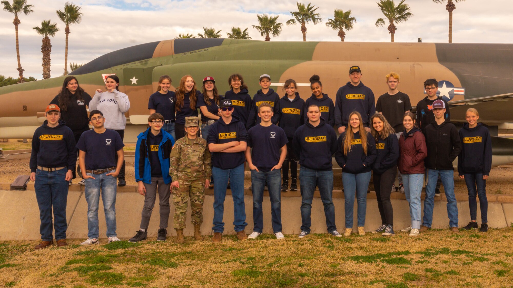 Students from the Prescott High School Air Force JROTC unit pose in front of a decommissioned McDonnell F-4 Phantom II, February 21, 2023, at Luke Air Force Base, Arizona.