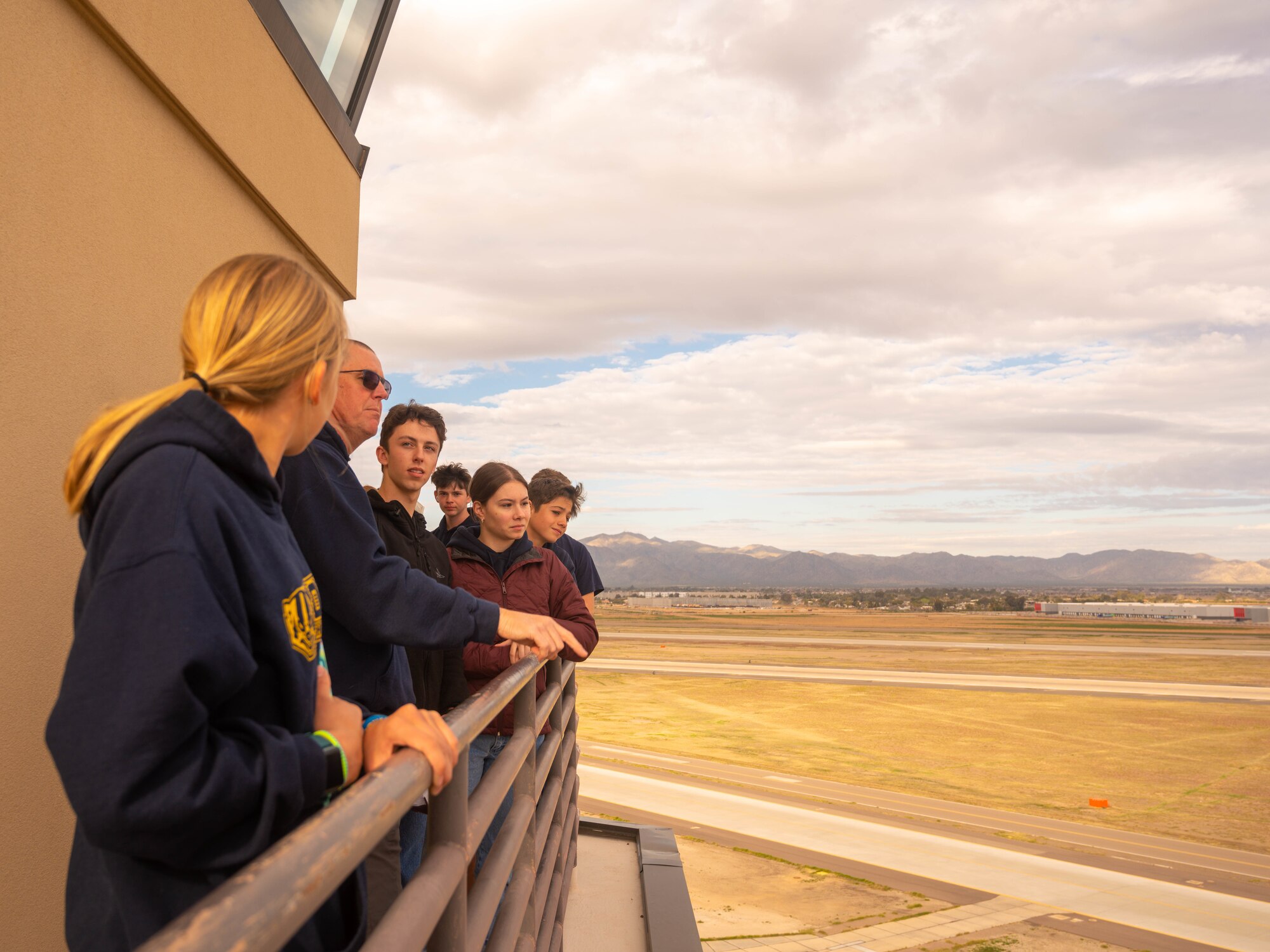 Students from the Prescott High School Air Force JROTC unit, survey the airfield during a tour Feb. 21, 2023, at Luke Air Force Base, Arizona.