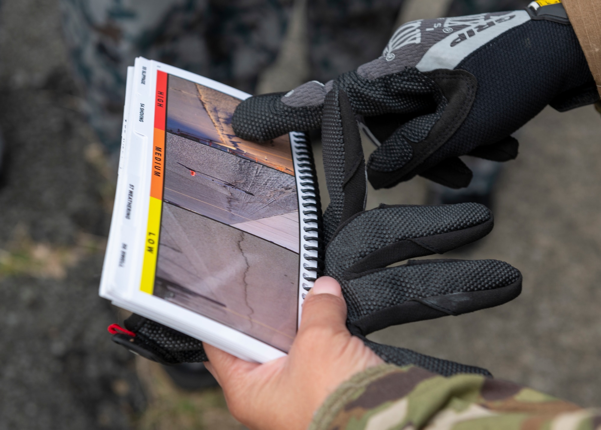 U.S. Air Force Master Sgt. Yelida Del Valle Ruiz, 554th Red Horse Squadron contingency airfield pavement evaluator, instructs Japan Maritime Self-Defense Force members on how to use a Dynamic Cone Penetrometer (DCP) for airfield survey operations during the Cope North 23 exercise, on the remote island of Iwo Jima, Japan, Feb. 21, 2023.