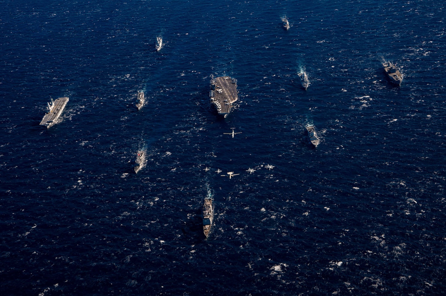 Aircraft assigned to Carrier Air Wing (CVW) 1 Italian Navy fly over the ships from Harry S. Truman Carrier Strike Group (CSG) 8, Standing NATO Maritime Group (SNMG) 2, the Italian Navy Cavour-class aircraft carrier ITS Cavour (CVH 550), the Andrea Doria-class air defense destroyer ITS Andrea Doria (D 553), and the Blue Ridge-class command and control ship USS Mount Whitney (LCC 20) transit the Adriatic Sea in support of Neptune Strike 22, Feb. 2, 2022. Neptune Strike 22 highlights the natural evolution of NATO’s ability to integrate the high-end maritime warfare capabilities of a carrier strike group to support the defense of the Alliance.