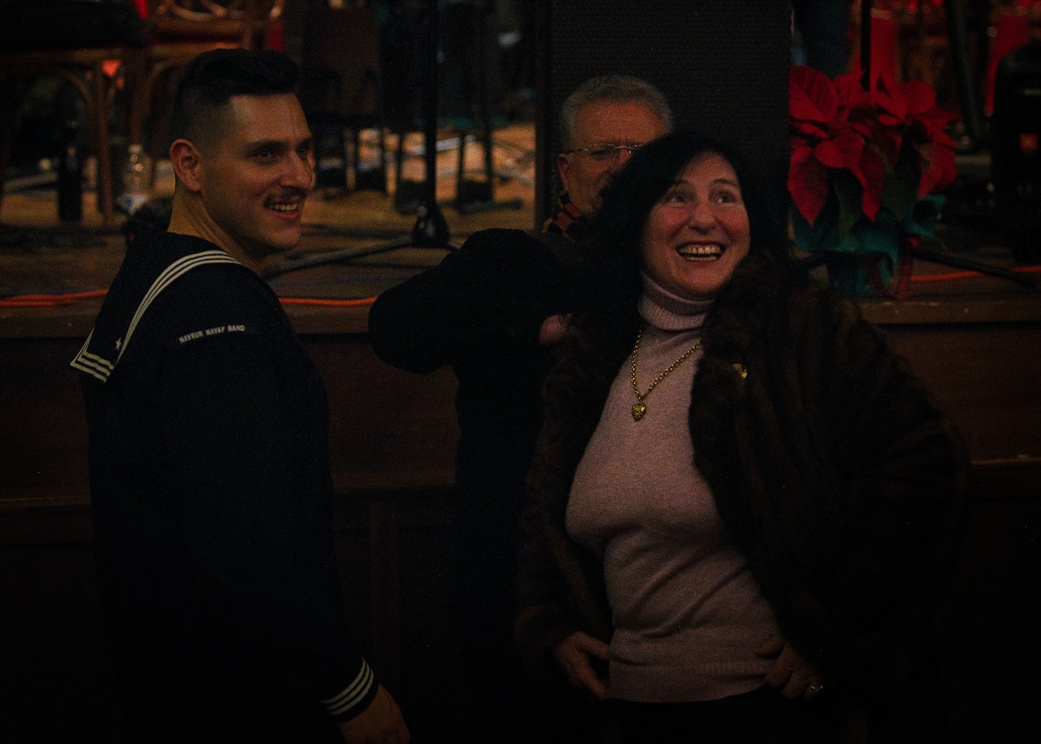 (Dec. 15, 2022) Musician 3rd Class Robert Novoa, member of the U.S. Naval Forces Europe-Africa (NAVEUR-NAVAF) Band, meets with an audience member following a concert at Teatro Garibaldi in Santa Maria Capua Vetere, Italy, Dec. 15, 2022. NAVEUR-NAVAF operates U.S. naval forces in the U.S. European Command (USEUCOM) and U.S. Africa Command (USAFRICOM) areas of responsibility. U.S. Sixth Fleet is permanently assigned to NAVEUR-NAVAF, and employs maritime forces through the full spectrum of joint and naval operations.