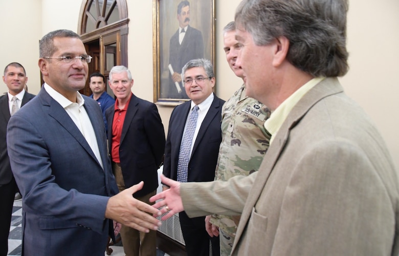 Puerto Rico Governor, Pedro Pierluisi greets U. S. Army Corps of Engineers Deputy District Engineer for Programs and Planning as South Atlantic Division Commanding General, Brig. General Daniel Hibner as Jaime A. Pinkham, The Principal Deputy Assistant Secretary of the Army Civil Works looks on  during a visit and discussion of ongoing U.S. Army Corps Engineers projects in Puerto Rico on Dec. 8, 2022 in San Juan. (USACE photos by Mark Rankin)