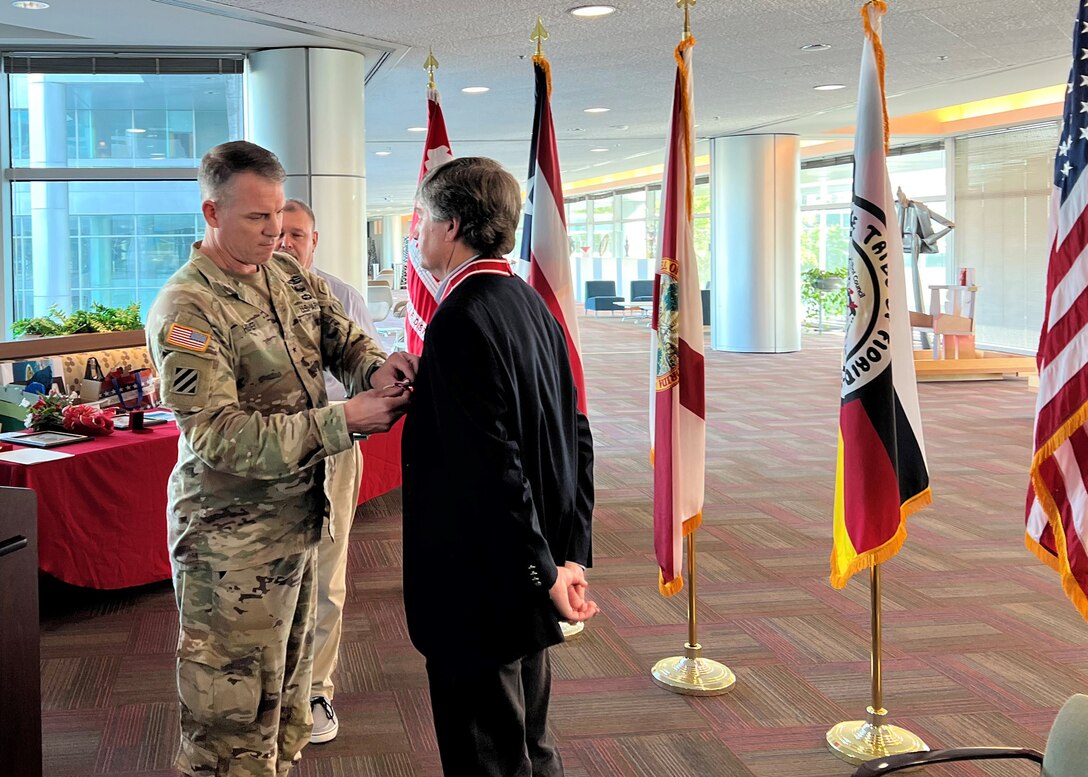 Brig. Gen. Daniel Hibner, the South Atlantic Division commanding general presents Tim Murphy with the Department of the Army's Superior Civilian Service Medal on Dec. 15, 2022. (USACE photo by Mark Rankin)