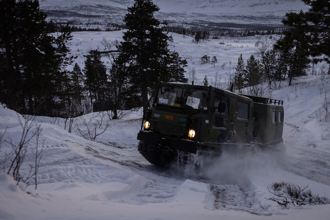 A U.S. Marine with 2d Combat Engineer Battalion, 2d Marine Division, operates a Bandvagn 206 during the Belted Vehicle Course in Forset, Norway, Dec. 10, 2022. The Belted Vehicle Course teaches Marines technical knowledge and proficiency in operating the Bandvagn 206 in the arctic environment. (U.S. Marine Corps photo by Lance Cpl. Averi Rowton)