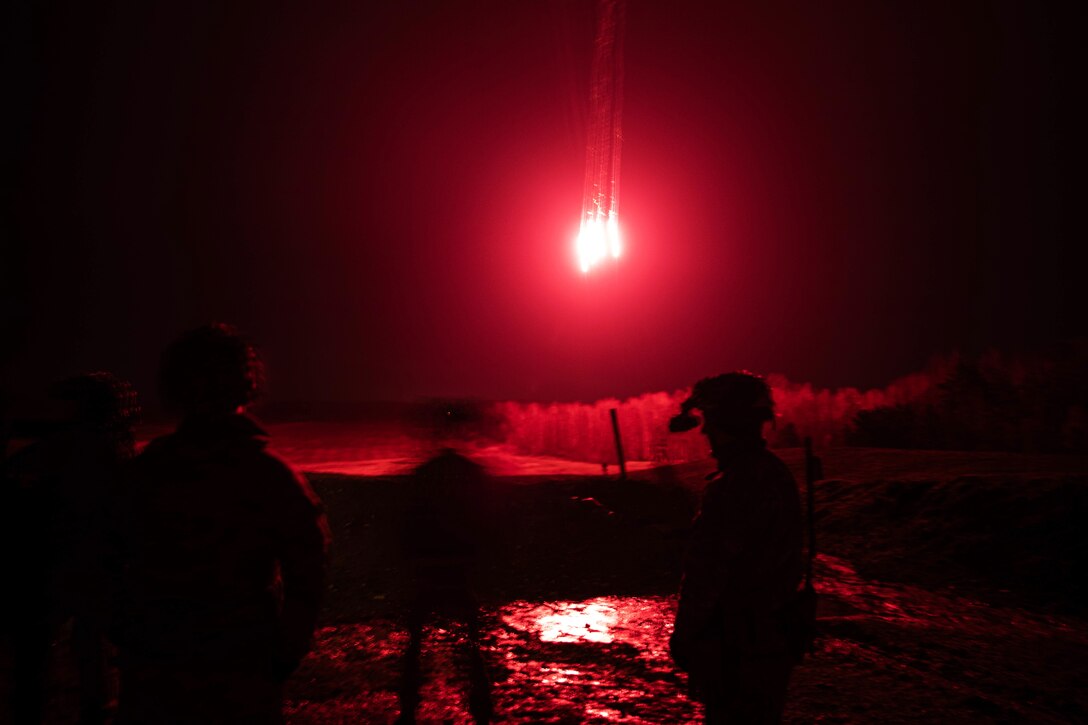 Soldiers conduct night live-fire training.