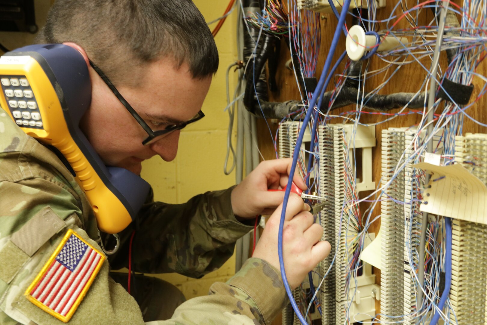 Spc. Kaden Scherger, with the 1137th Signal Company TIN-E (Tactical Installation and Networking-Enhanced), tests network connections during an infrastructure improvement project April 26, 2022, at Rickenbacker Air National Guard Base in Columbus, Ohio. The 1137th's primary mission to install and maintain computer network infrastructure.