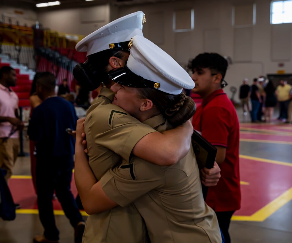 Pfc. Kylie Hathaway celebrates with a fellow graduate on Marine Corps Recruit Depot Parris Island S.C., May 27, 2022. Hathaway began training on the west coast at Marine Corps Recruit Depot San Diego and was transferred to MCRD Parris Island after an injury to her tibia required her to enter a recovery platoon. (U.S. Marine Corps photo by Lance Cpl. Michelle Brudnicki)