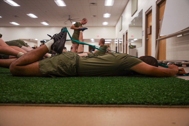 A recruit with Romeo Company, Support Training Battalion, stretches on Marine Corps Recruit Depot Parris Island S.C., Sep. 26, 2022. Romeo Company, formerly known as Special Training Company, is a rehabilitation, recovery, and reconditioning company with the mission of getting recruits back to the fight. (U.S. Marine Corps Photo by Sgt. Ryan Hageali)
