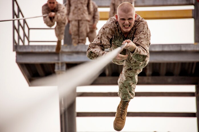 U.S. Marine Corps Recruit Hunter Garcia with Delta Company, 1st Recruit Training Battalion, completes the "slide for life" obstacle during the confidence course at Marine Corps Recruit Depot San Diego, Dec. 27, 2022.