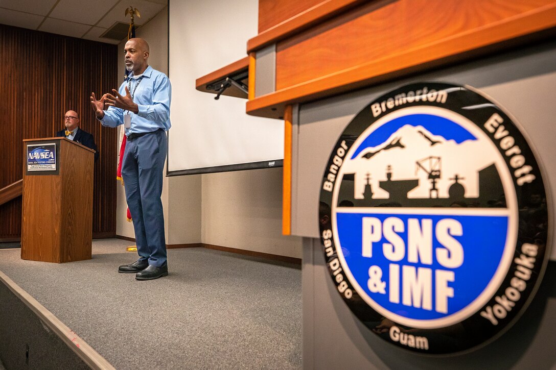 Mike Irby, then-deputy production resources officer, Code 901,
Production Resources, speaks at an event for Shop 75, Dismantlers, celebrating their 10 year anniversary at PSNS & IMF. Shop 75 was initally stood up as a project-specific shop for USS Enterprise (CVN 65) (U.S. Navy photo by Scott Hansen).