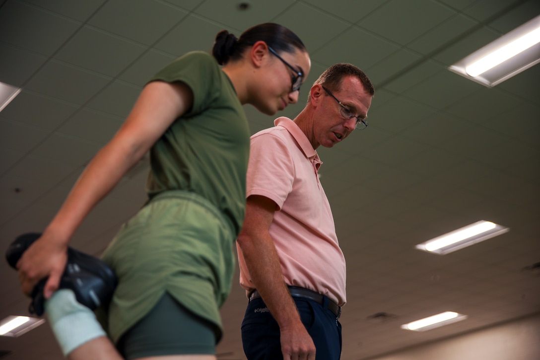 Sports Medicine Injury Prevention Trainer Jay Gibson assists recruits with Romeo Company, Support Training Battalion on Marine Corps Recruit Depot Parris Island S.C., Sep. 28, 2022. Romeo Company, formerly known as Special Training Company, is a rehabilitation, recovery, and reconditioning company with the mission of getting recruits back to the fight. (U.S. Marine Corps Photo by Sgt. Ryan Hageali)