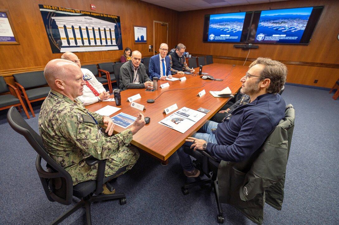 Capt. Jip Mosman, commander, Puget Sound Naval Shipyard & Intermediate Maintenance Facility, shares his perspective with Simon Sinek during an office call Dec. 12, 2022, at the shipyard in Bremerton, Washington. (U.S. Navy photos by Scott Hansen)