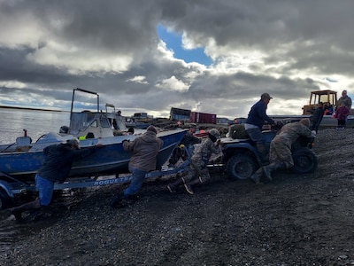 Service members assigned to Joint Task Force – Bethel work with the local community of Chevak, Alaska in towing a boat from the river as part of Operation Merbok Response, Sept. 22, 2022. More than 130 members of the Alaska Organized Militia, which includes members of the Alaska National Guard, Alaska State Defense Force and Alaska Naval Militia, were activated following a disaster declaration issued Sept. 17 after the remnants of Typhoon Merbok caused dramatic flooding across more than 1,000 miles of Alaskan coastline. (Alaska National Guard photo by Senior Airman Emily Batchelor)