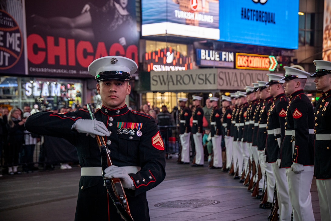 Corporal Steven Almaguer, number one rifle inspector, conducts his rifle inspection during a performance at Times Square celebrating the 247th Marine Corps Birthday in New York on Nov.  10, 2022. This weekend marked the final performances of several Marines in the Silent Drill Platoon as they prepared to rotate to their following duty stations in the Fleet Marine Force. Fair winds and following seas, Marines. (U.S. Marine Corps photo by Cpl. Mark Morales)