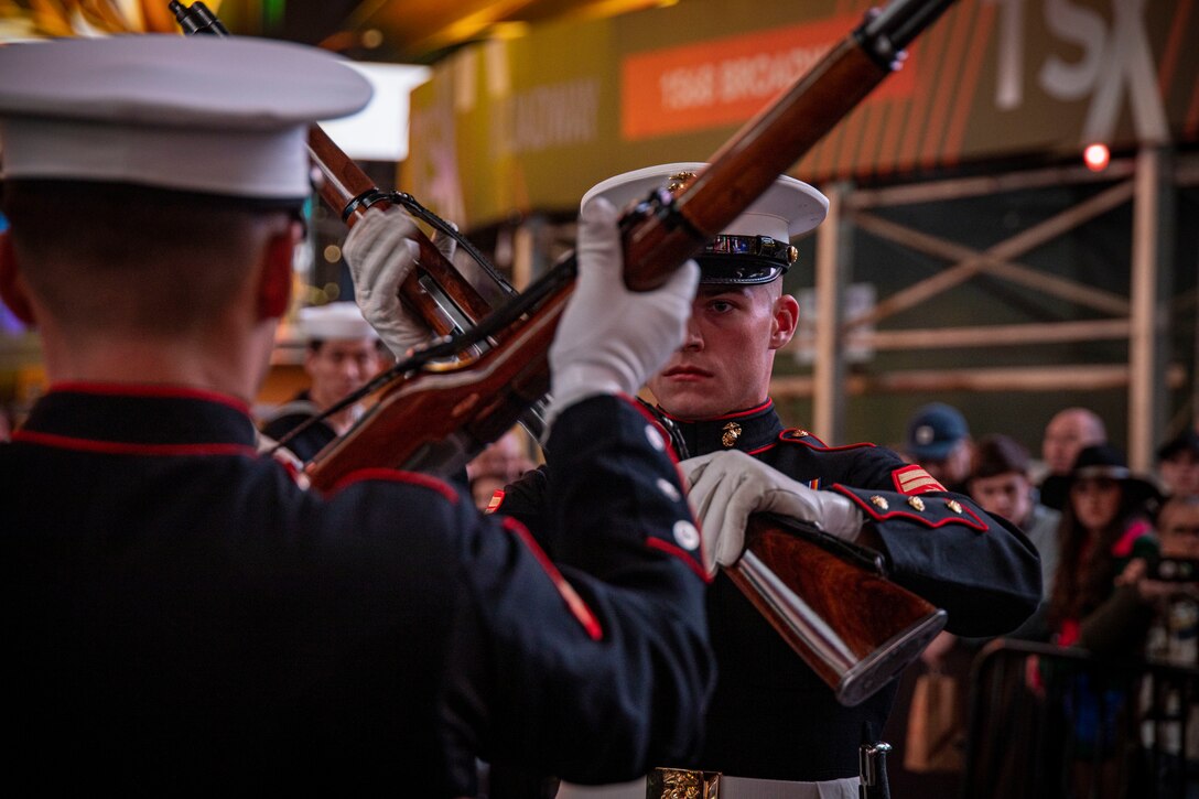 Corporal Benjamin Gabica, Drill Master, executes his rifle inspection during a performance at Times Square celebrating the 247th Marine Corps Birthday in New York on Nov. 10, 2022. This weekend marked the final performances of several Marines in the Silent Drill Platoon as they prepared to rotate to their following duty stations in the Fleet Marine Force. Fair winds and following seas, Marines. (U.S. Marine Corps photo by Cpl. Mark Morales)