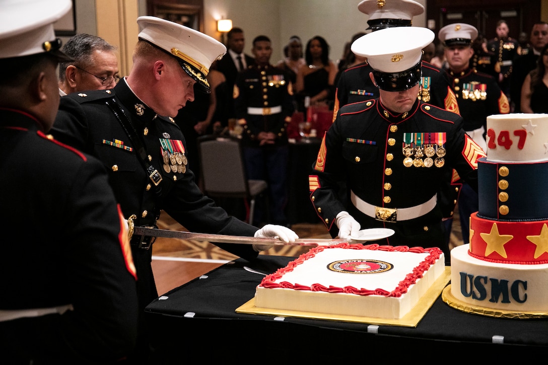 U.S. Marine Corps Maj. Michael Siani, Commanding Officer, Recruiting Station Dallas, cuts the cake during the ceremony to present to the guest of honor, Master Sgt. Victor Salinas, retired, at the 247th Marine Corps Birthday Ball held in Allen, Tx on Nov. 11, 2022. Since 1921, the Corps has celebrated their birthday and honored the legacy of the U.S. Marine Corps at the Marine Corps Ball. November 10 is the official birthday of the Marine Corps. (U.S. Marine Corps photo by 1st Lt. Tyler Maschal)