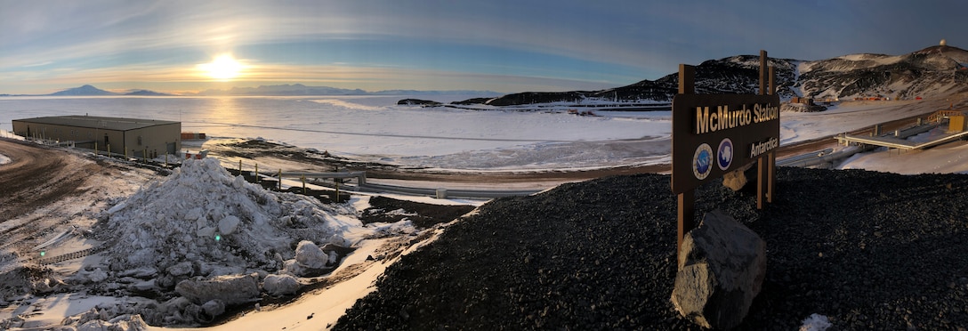 McMurdo Station sign stands in Arctic landscape.