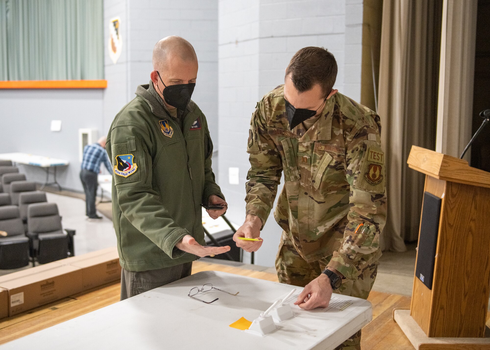 Capt. Kyle Matissek, 412th Test Wing Commander’s Action Group Director, verifies 412th Test Wing Commander, Brig. Gen. Matthew Higer’s personal information after submitting a COVID-19 self-test kit at the Single Point Screening Facility Test Facility (SPSTF) at the Base Theater on Edwards Air Force Base, California. The SPSTF will hold COVID-19 proactive screening tests Jan. 4-12, from 7:30 a.m. to 4 p.m. (Air Force photo by Giancarlo Casem)
